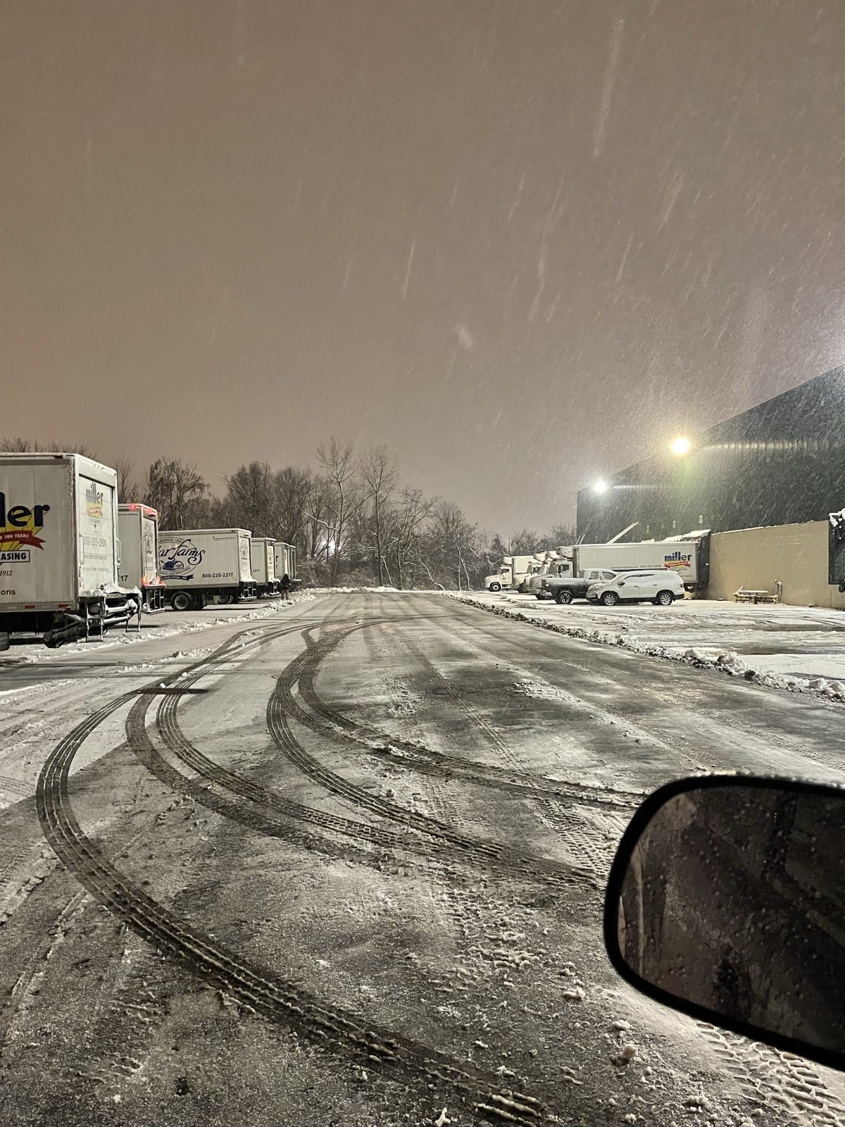 Freshly plowed lot at night during heavy snowfall, cleared by JD Home Construction